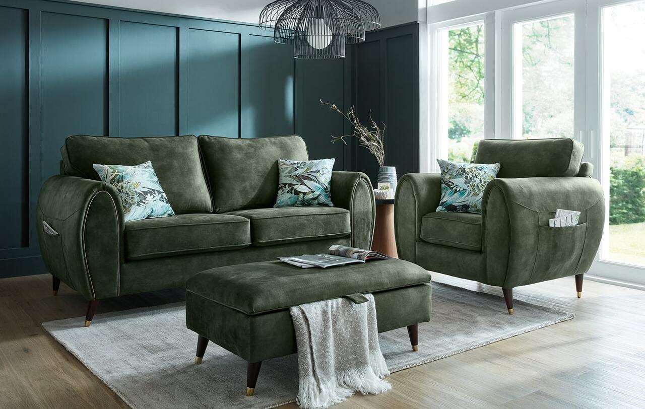 Green fabric sofa and armchair set with modern design and botanical cushions in a bright living room