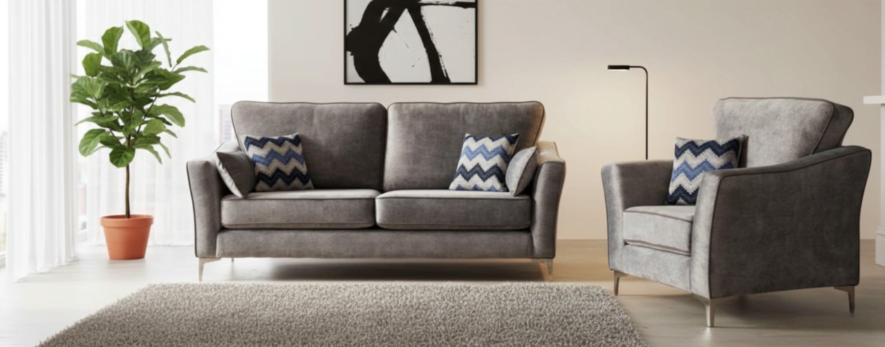 Grey sofa and armchair set with blue patterned cushions