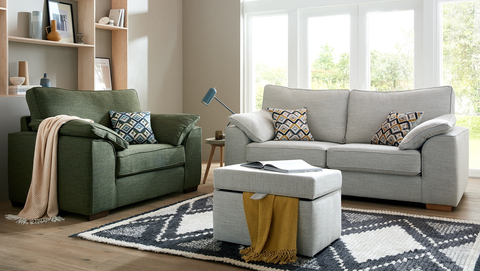 Light grey sofa with green armchair in modern living room