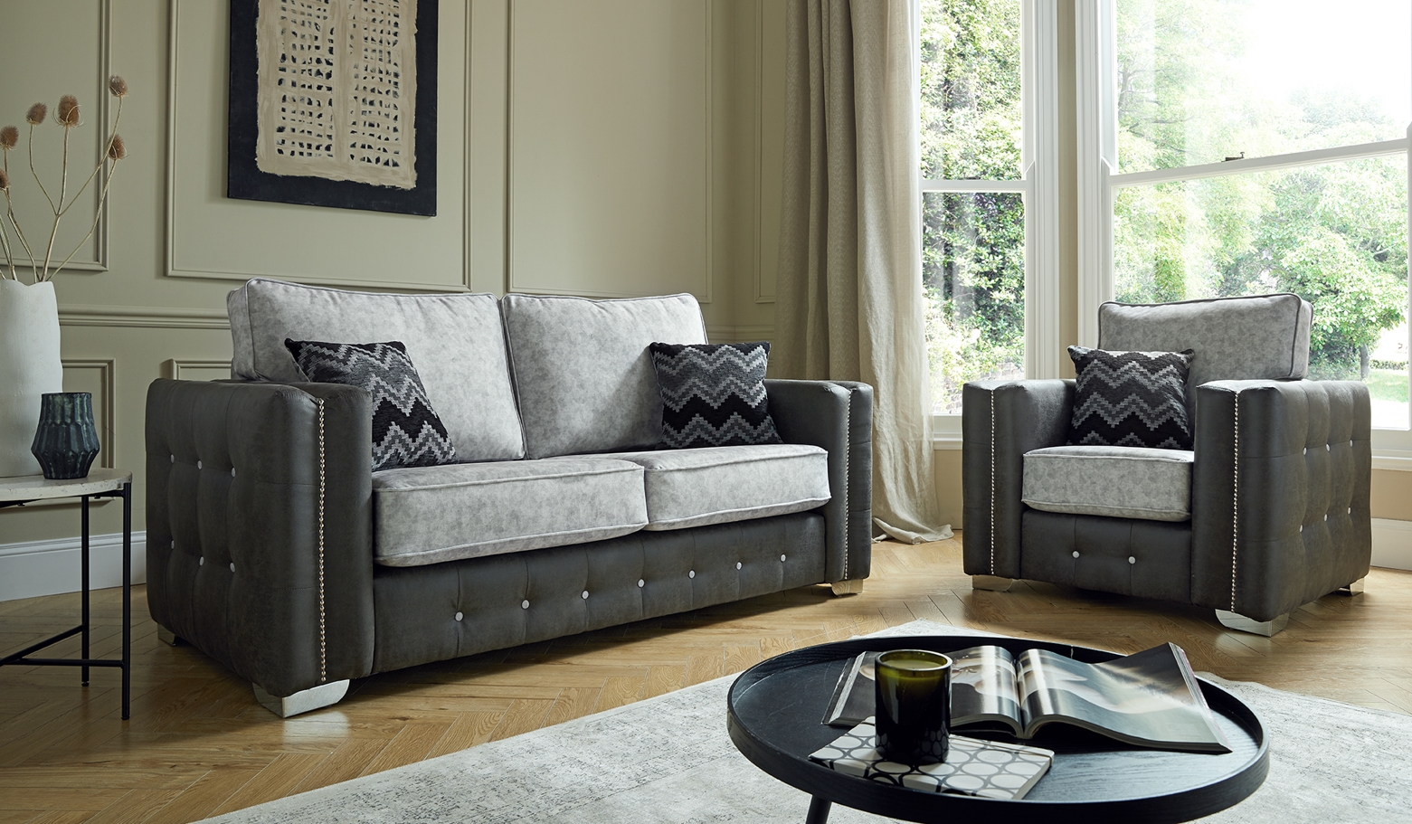 Two-tone grey sofa and armchair with light cushions and dark base