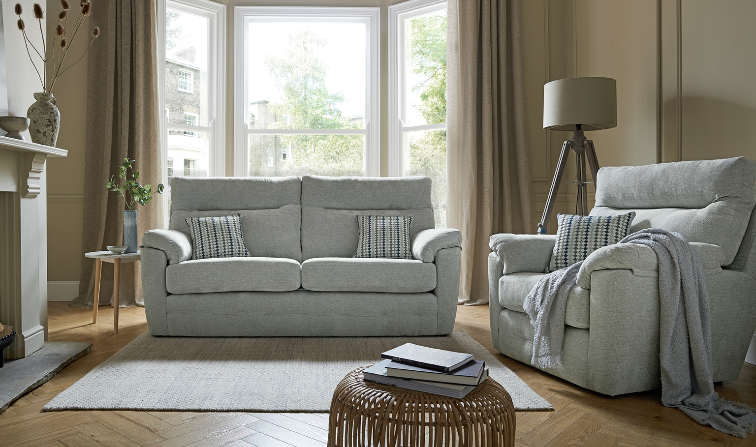 Light grey sofa and armchair in cozy neutral living room