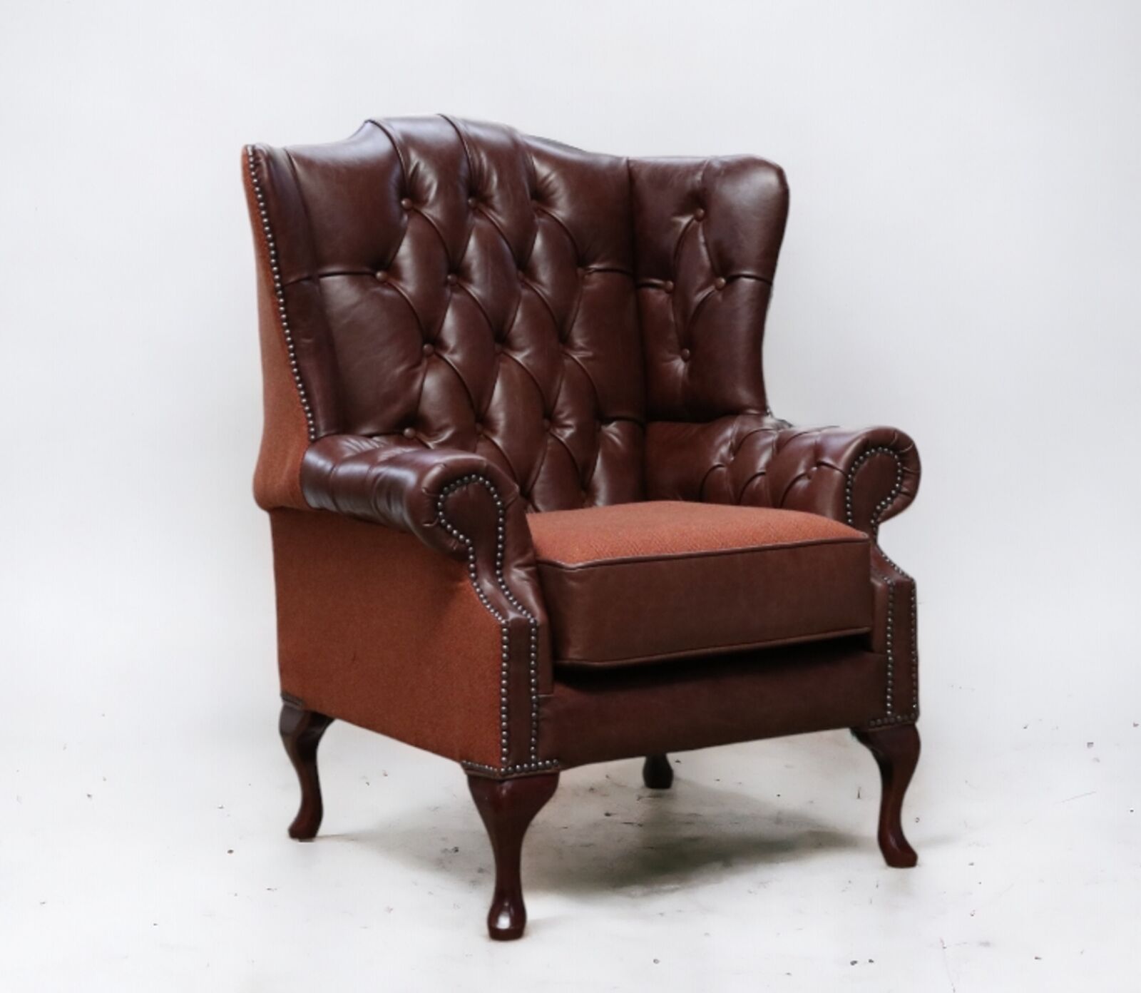 Product photograph of Chesterfield Ludlow High Back Wing Chair Newcastle Spice Leather And Carnegie Cinnamon Fabric Stock from Designer Sofas 4U