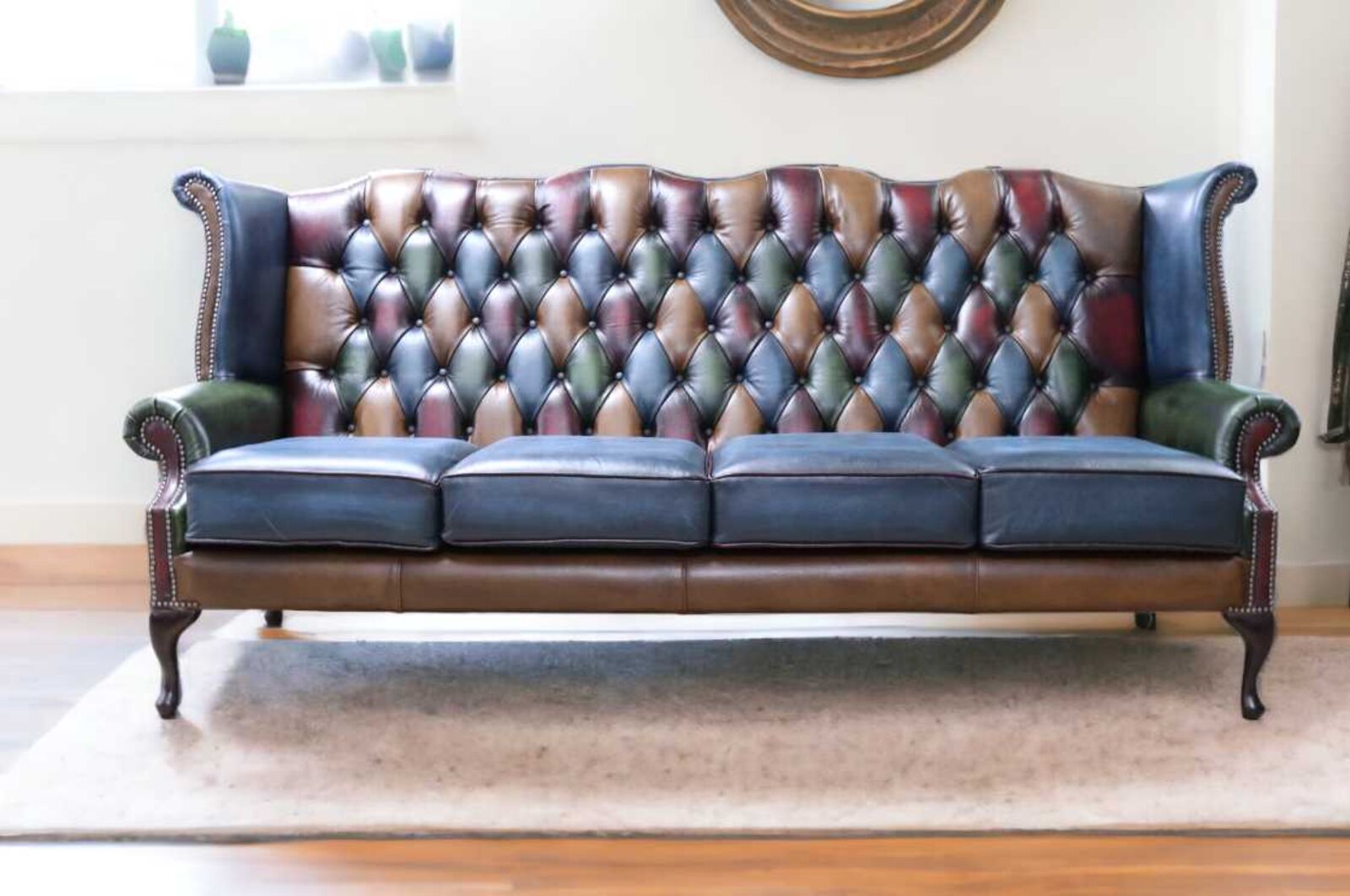 Product photograph of Chesterfield 4 Seater Queen Anne High Back Wing Sofa Antique Patchwork Leather from Designer Sofas 4U