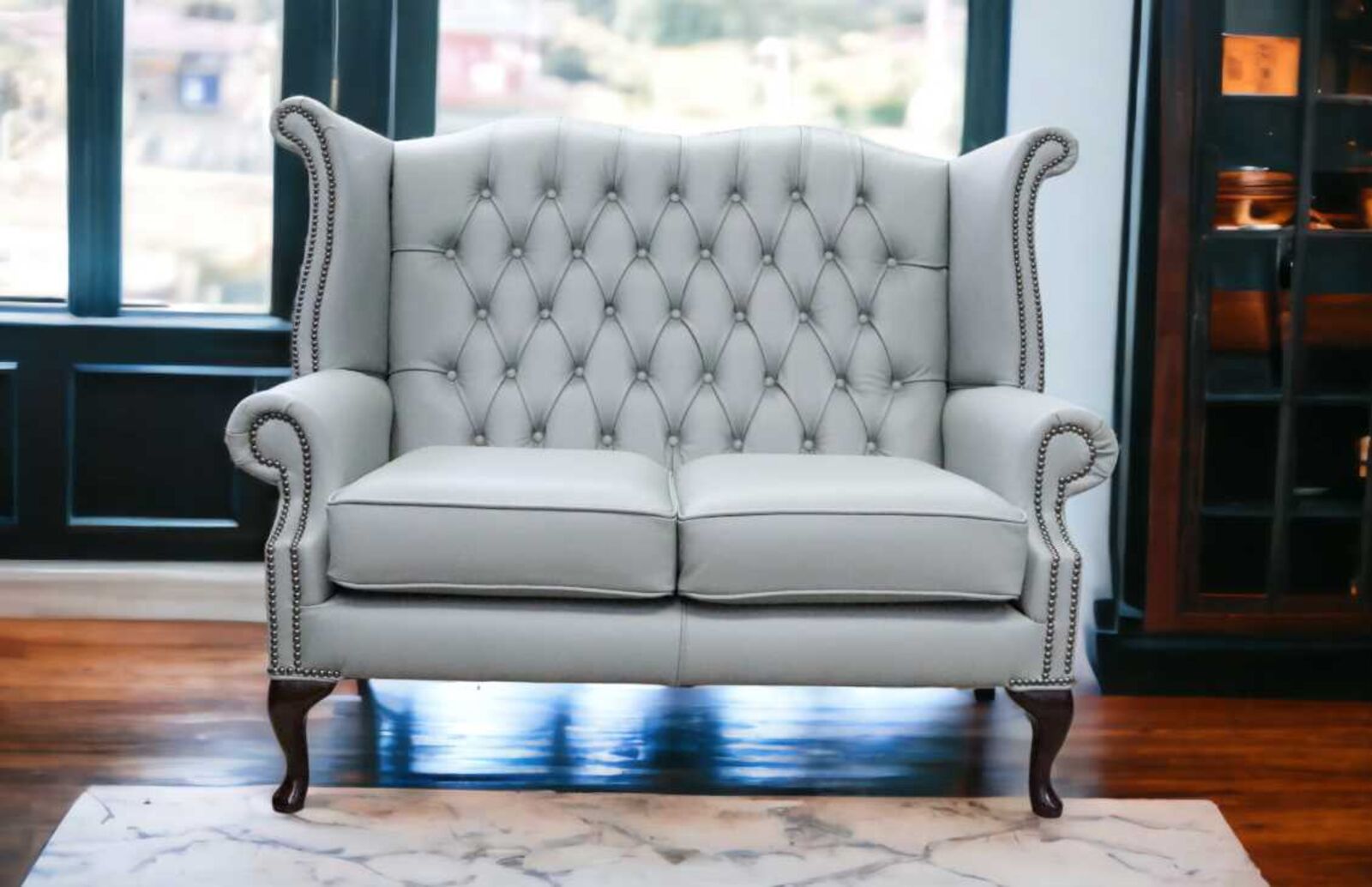 Product photograph of Chesterfield 2 Seater Queen Anne High Back Wing Sofa Moon Mist Grey Leather from Designer Sofas 4U